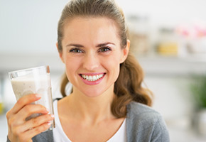 woman holding energy drink