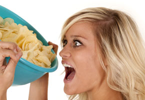 a woman tempted by a bowl of chips