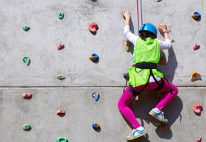 Youngster's effort in climbing a wall to reach the top