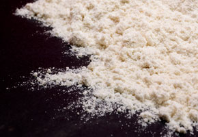 masa harina flour on a black soapstone surface
