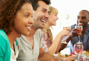 Group Of Friends Sitting Around Table Having Dinner Party