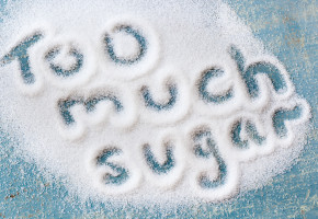 The words "too much sugar" written in sugar grains. Overhead vi