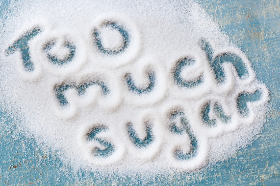 The words "too much sugar" written in sugar grains. Overhead vi